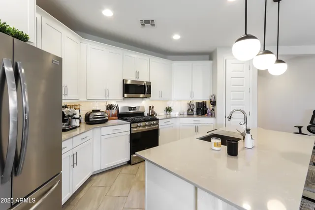 a kitchen with a sink a stove and refrigerator