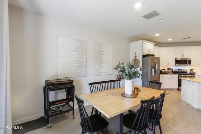 a kitchen with a table and chairs in it