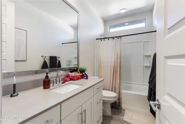 a bathroom with a sink mirror vanity and toilet