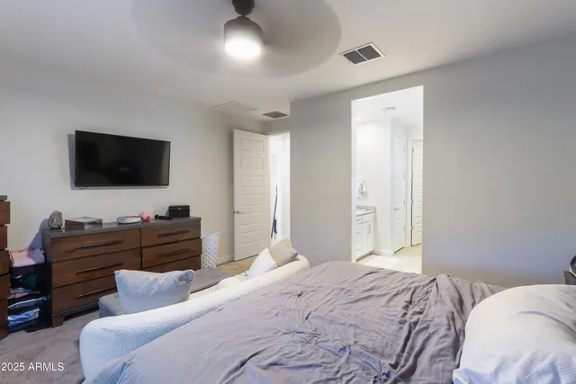 a bedroom with a bed and a flat screen tv