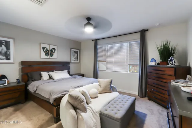 a bedroom with a large bed and a chandelier