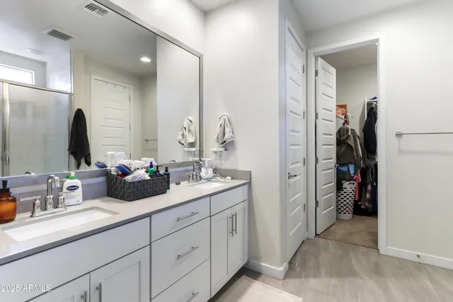 a bathroom with a double vanity sink and a mirror