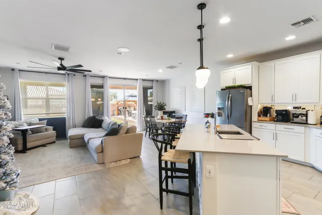 a kitchen with counter top space appliances and a chandelier