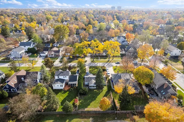 an aerial view of residential houses with outdoor space and swimming pool