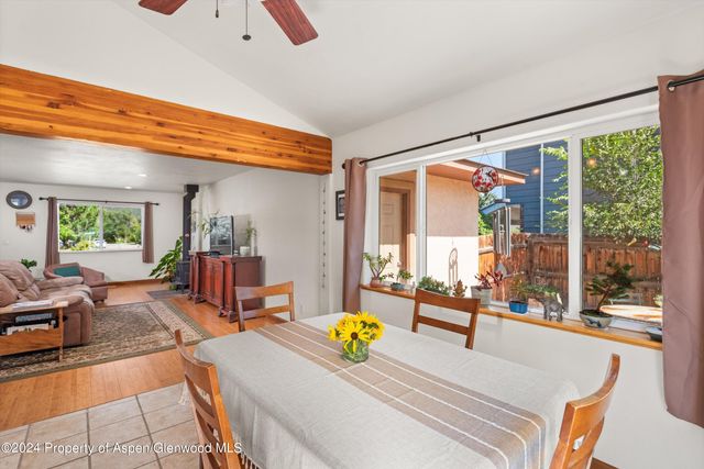 a view of living room filled with furniture and floor to ceiling window