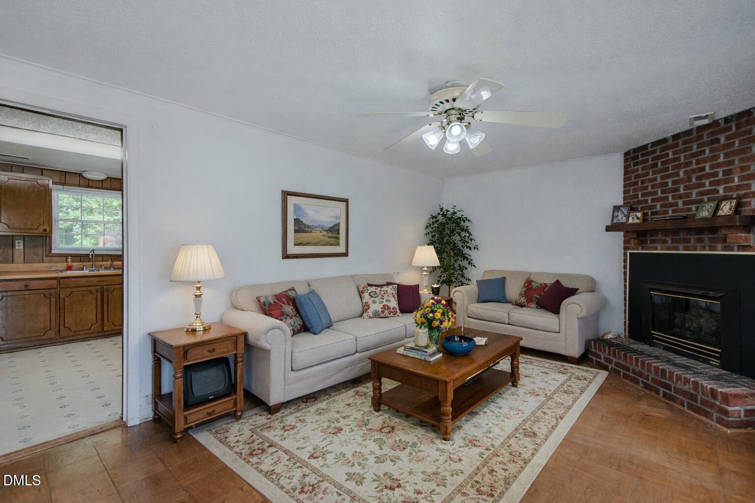 1302 Blacksmith Road Efland, NC 27243 - Photo 9 of 46 a living room with furniture a fireplace and a lamp