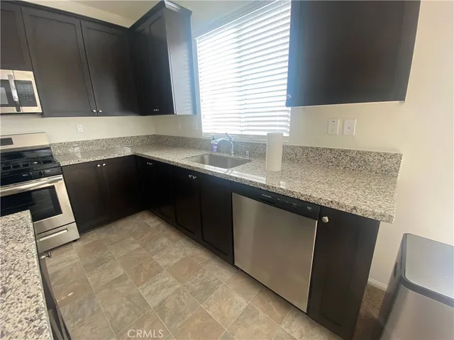 a view of a hallway with wooden floor and entryway