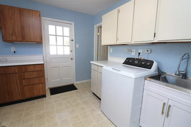 a kitchen with sink cabinets and window