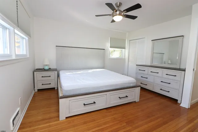 a bedroom with a bed and a dresser