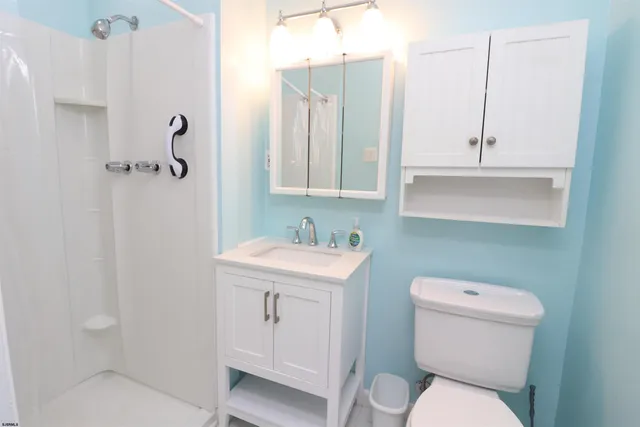 a bathroom with a toilet a sink and mirror