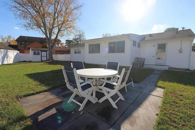 a outdoor space with a table and chairs