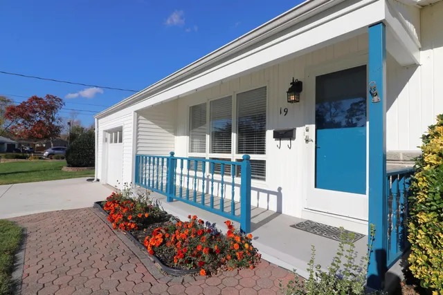 a view of a house with a flower garden