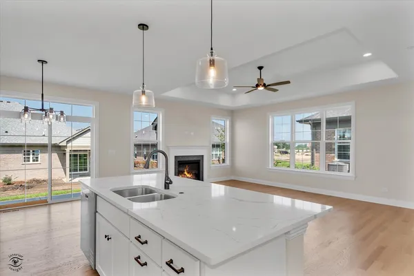 a view of a kitchen counter top space with furniture and fireplace