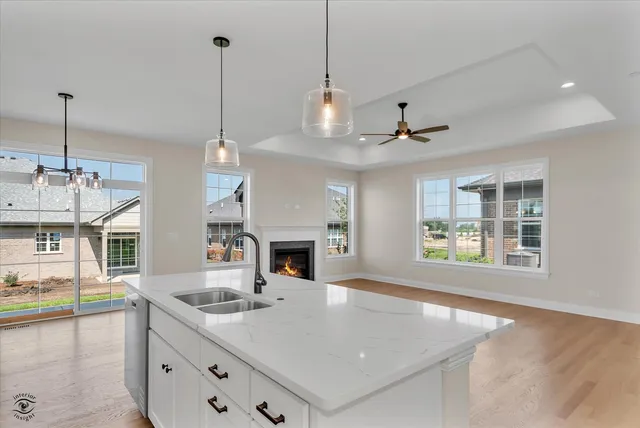 a view of a kitchen counter top space with furniture and fireplace