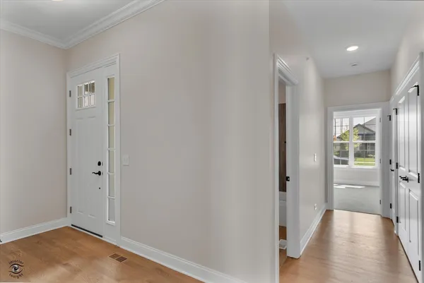 a view of a hallway with wooden floor