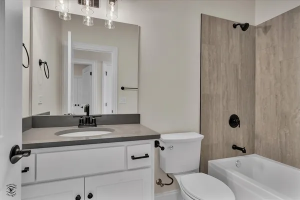 a kitchen with white cabinets and sink
