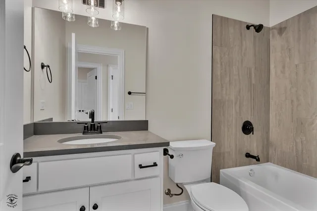 a kitchen with white cabinets and sink