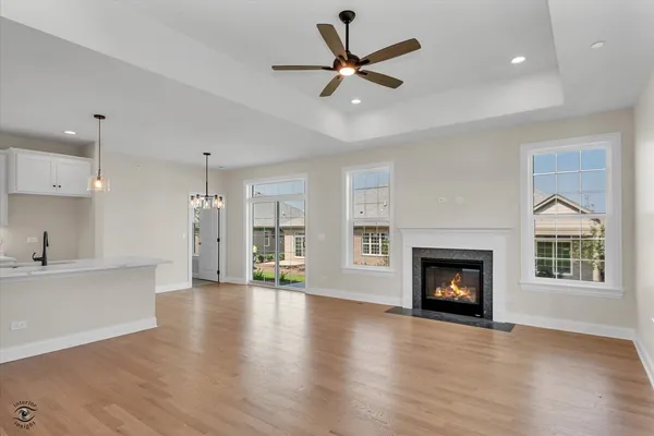 a view of an empty room with a fireplace and a window