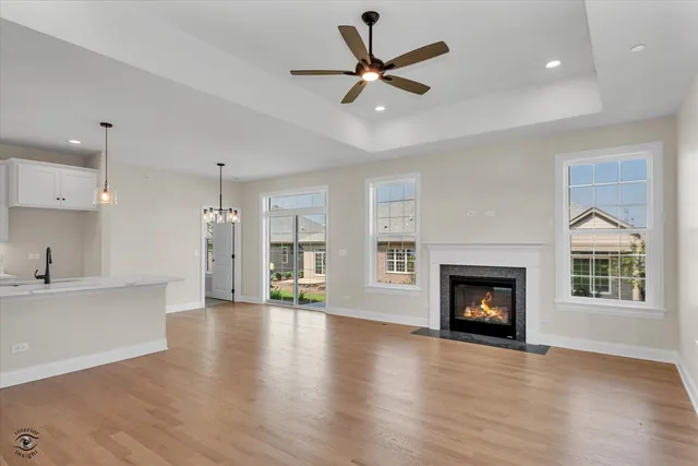 a view of an empty room with a fireplace and a window