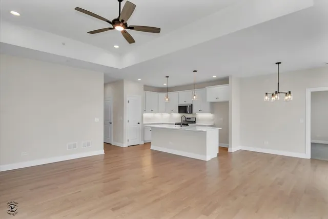a view of kitchen with sink microwave and stove