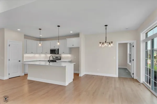 a kitchen with stainless steel appliances kitchen island a sink and a refrigerator