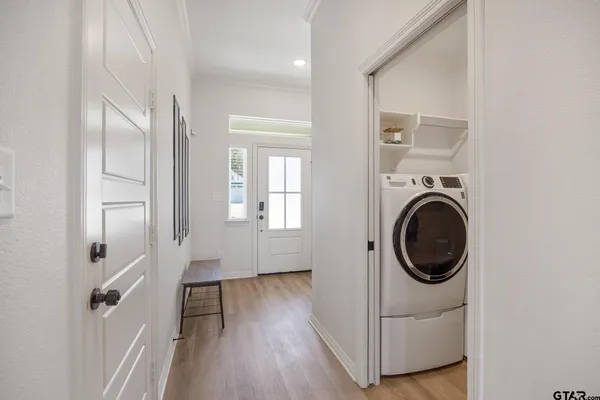 a kitchen with stainless steel appliances granite countertop a sink a refrigerator and a granite counter tops with white cabinets