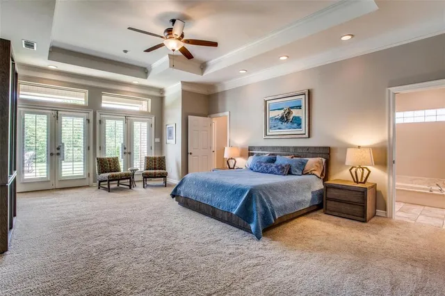 a spacious bedroom with a bed a table and chairs