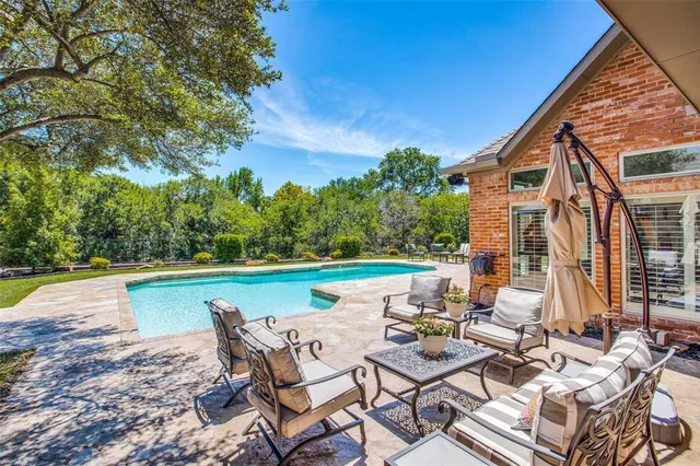a view of swimming pool with lounge chairs
