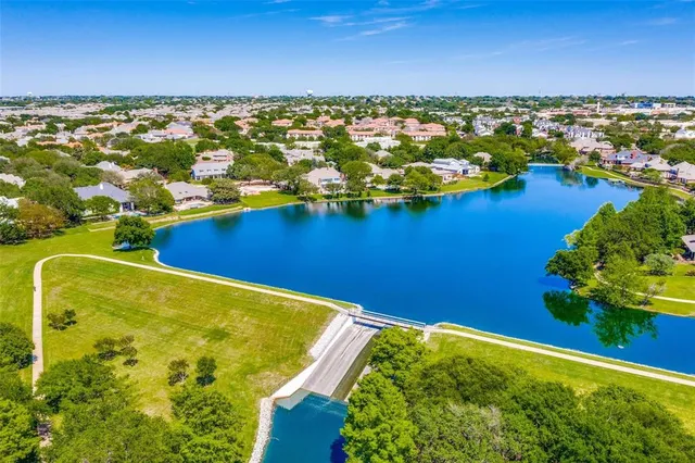 an aerial view of residential houses with lake view