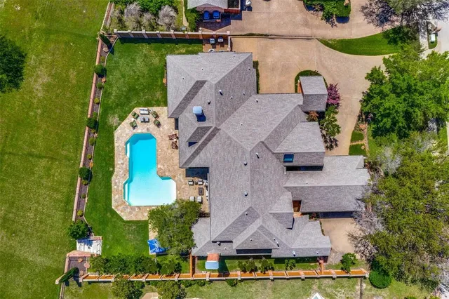 an aerial view of residential houses with outdoor space and parking