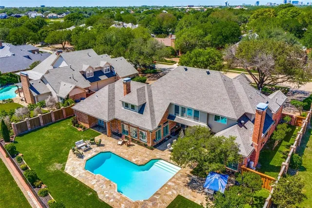 an aerial view of residential house with outdoor space and swimming pool