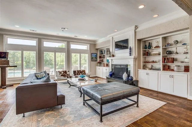 a living room with furniture large window and a fireplace