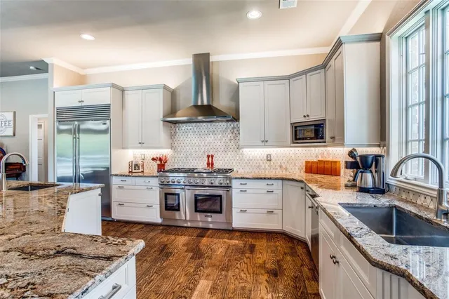 a kitchen with stainless steel appliances granite countertop a sink stove and refrigerator