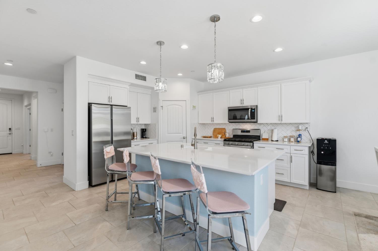 6326 West Richert Avenue Fresno, CA 93723 - Photo 8 of 45 a kitchen with kitchen island white cabinets and stainless steel appliances