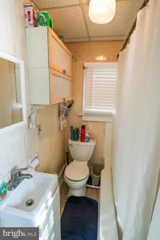 a bedroom with furniture and gym equipment