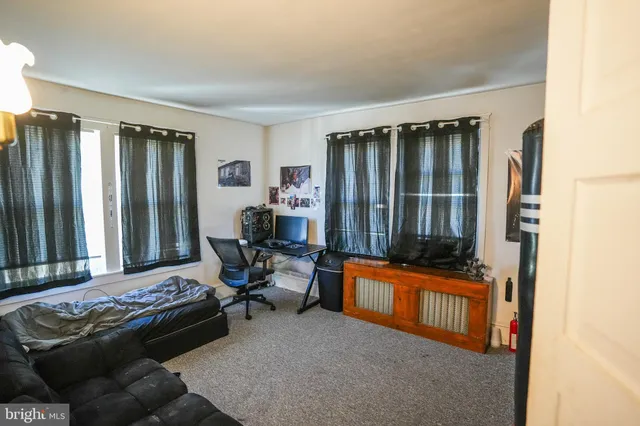 a kitchen with a refrigerator a sink dishwasher a dining table and chairs with wooden floor