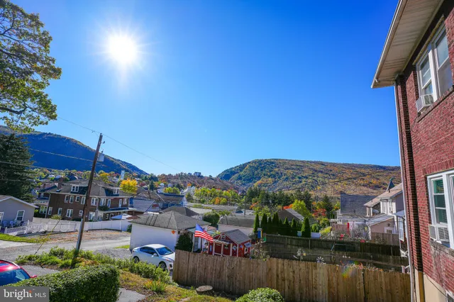 a view of a chairs and table in patio with a lake view
