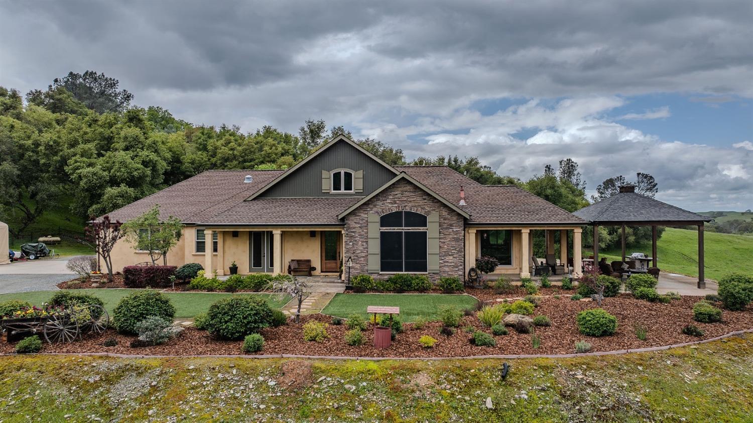 a front view of a house with garden
