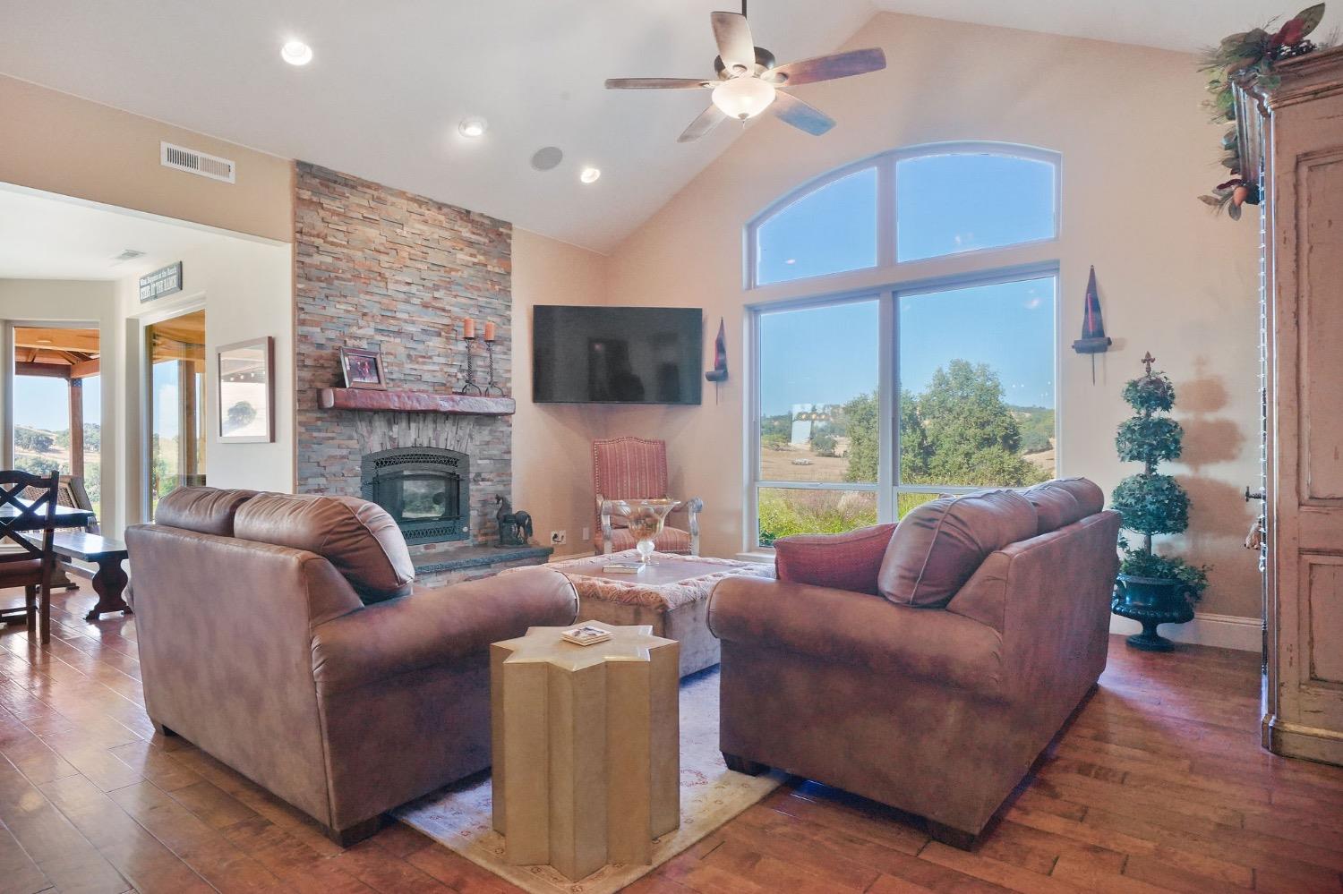 11195 Vintage Road Ione, CA 95640 - Photo 12 of 92 a living room with furniture a large window and a fireplace