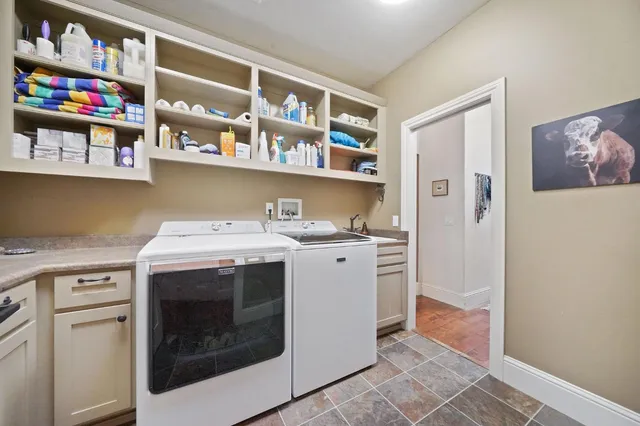 a dining room with furniture a floor to ceiling window and wooden floor