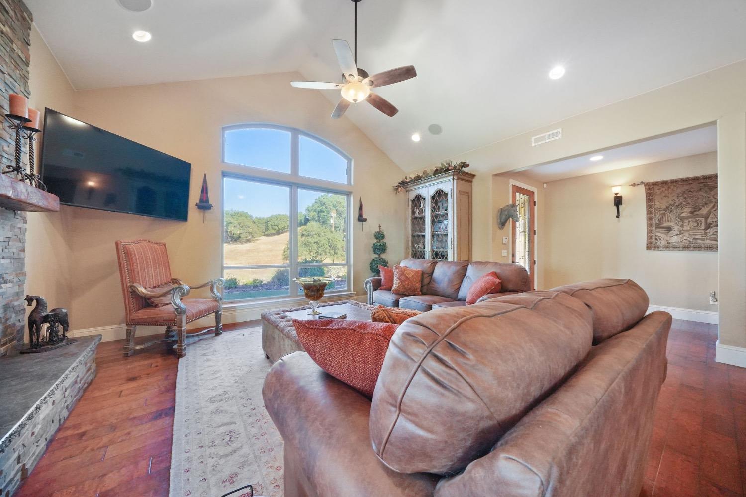 11195 Vintage Road Ione, CA 95640 - Photo 16 of 92 a living room with furniture a flat screen tv and a large window