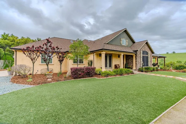 a kitchen with granite countertop a refrigerator and a sink