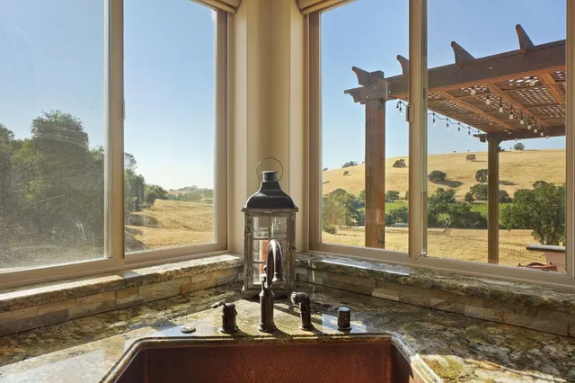 a bathroom with a granite countertop shower sink and mirror