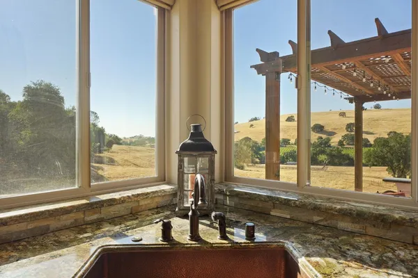 a bathroom with a granite countertop sink mirror and shower