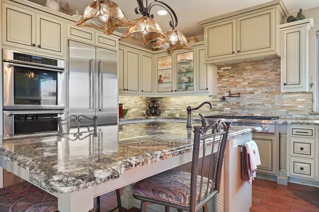 a bathroom with a granite countertop sink mirror and shower