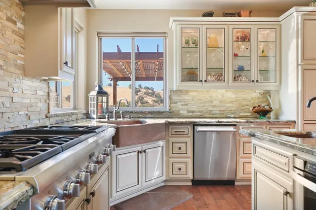 a bathroom with a granite countertop sink mirror and shower
