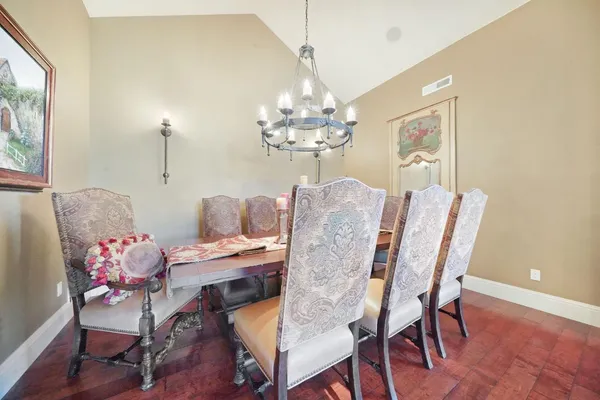 a view of a dining room with furniture and a potted plant