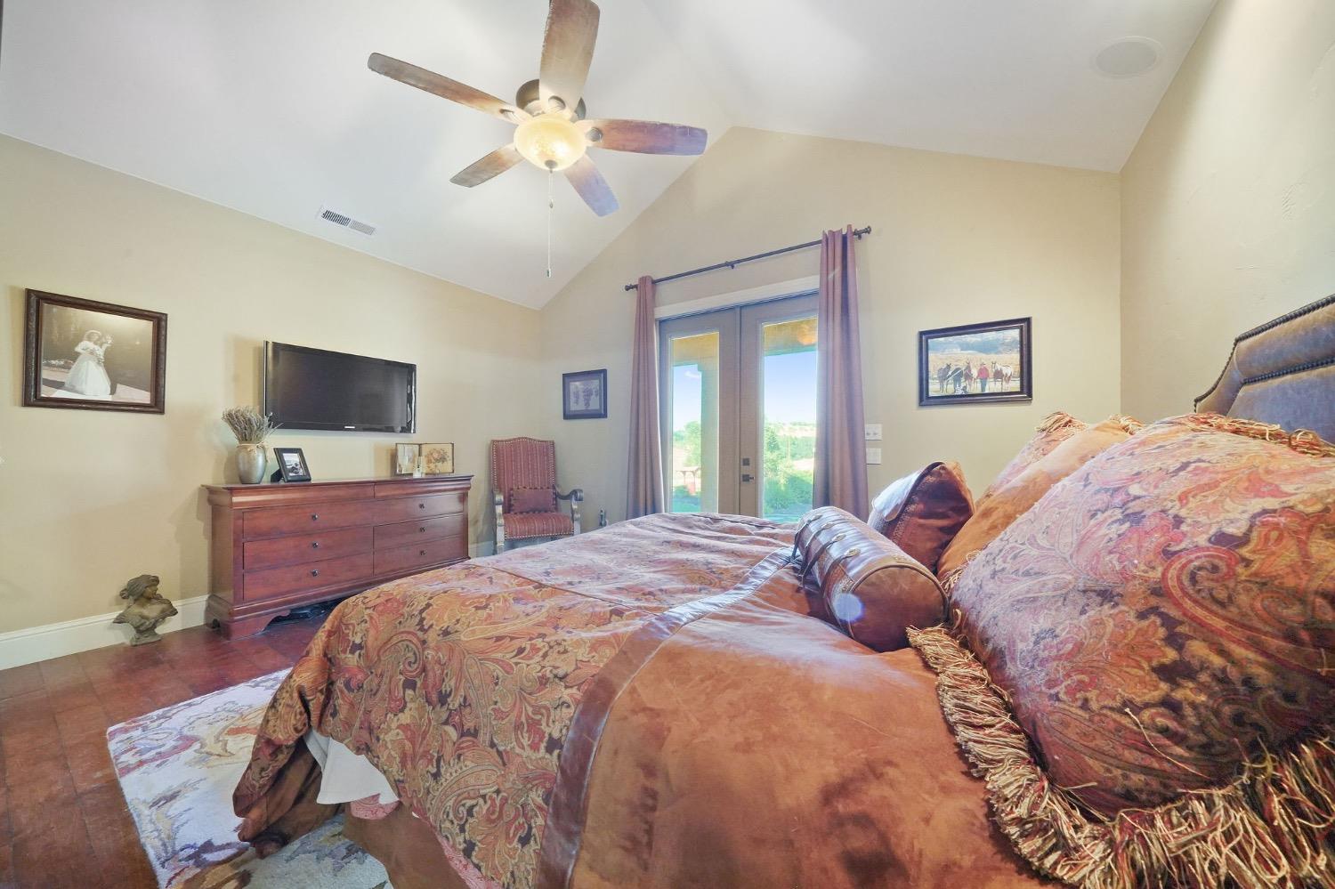 11195 Vintage Road Ione, CA 95640 - Photo 40 of 92 a bedroom with a large bed and a flat screen tv