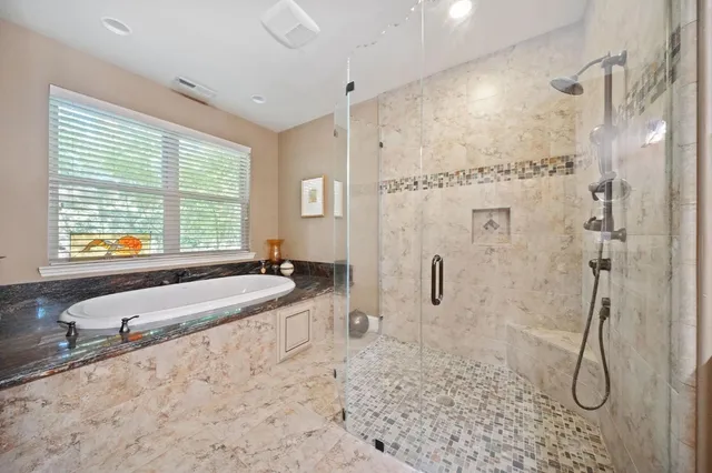 a en suite bathroom with a granite countertop sink and a mirror