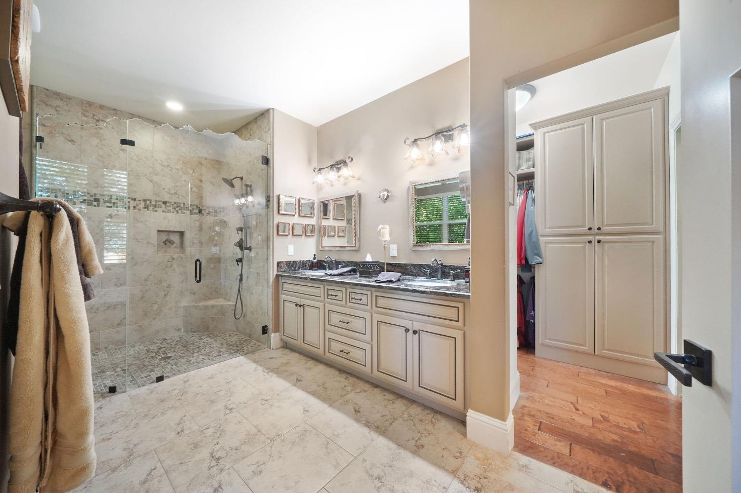 11195 Vintage Road Ione, CA 95640 - Photo 44 of 92 a bathroom with a granite countertop sink mirror and shower